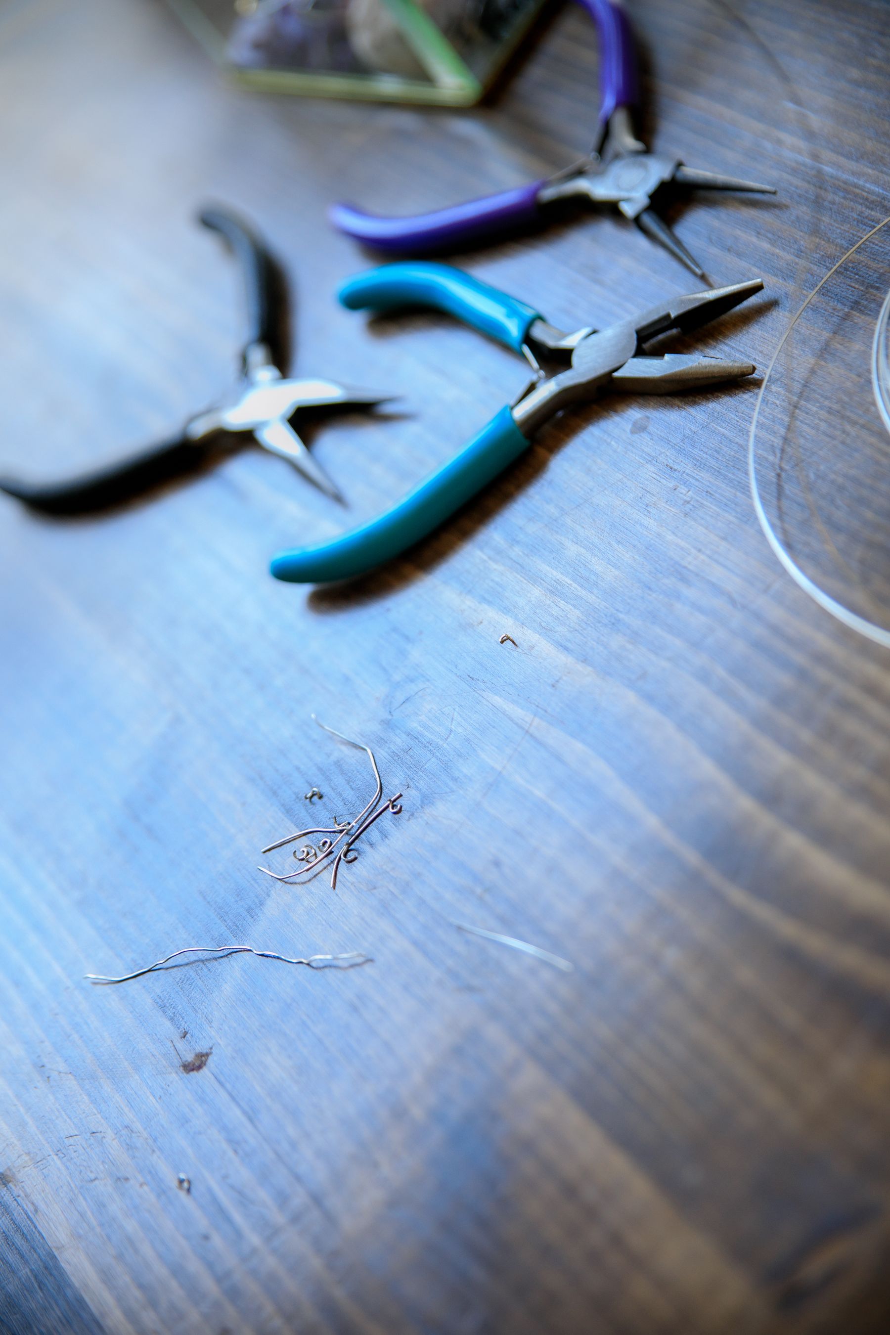 Jeweler's pliers and wire on a workbench